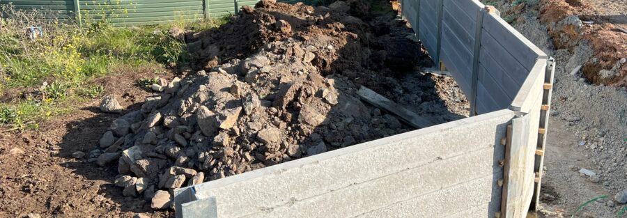 principles of retaining wall design and placement, including drainage, height requirements, material selection, and compliance