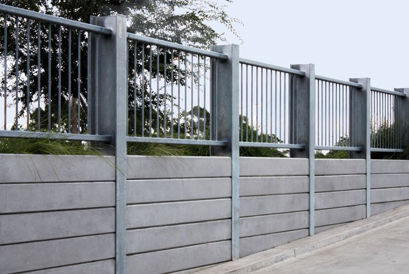 Concrete sleeper retaining wall with steel posts and steel balustrade above