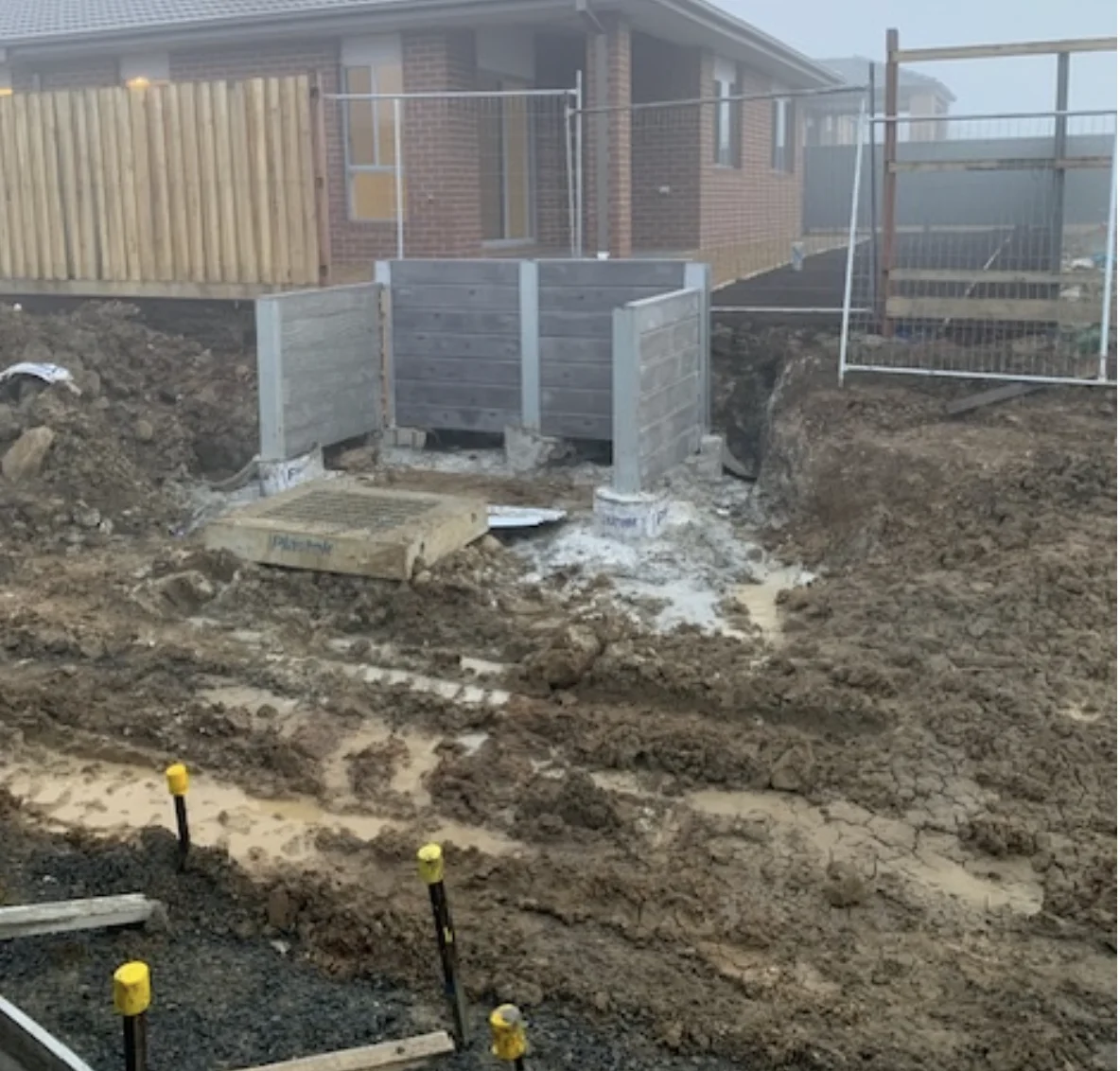 U-shaped concrete sleeper retaining wall during construction in Lucas
