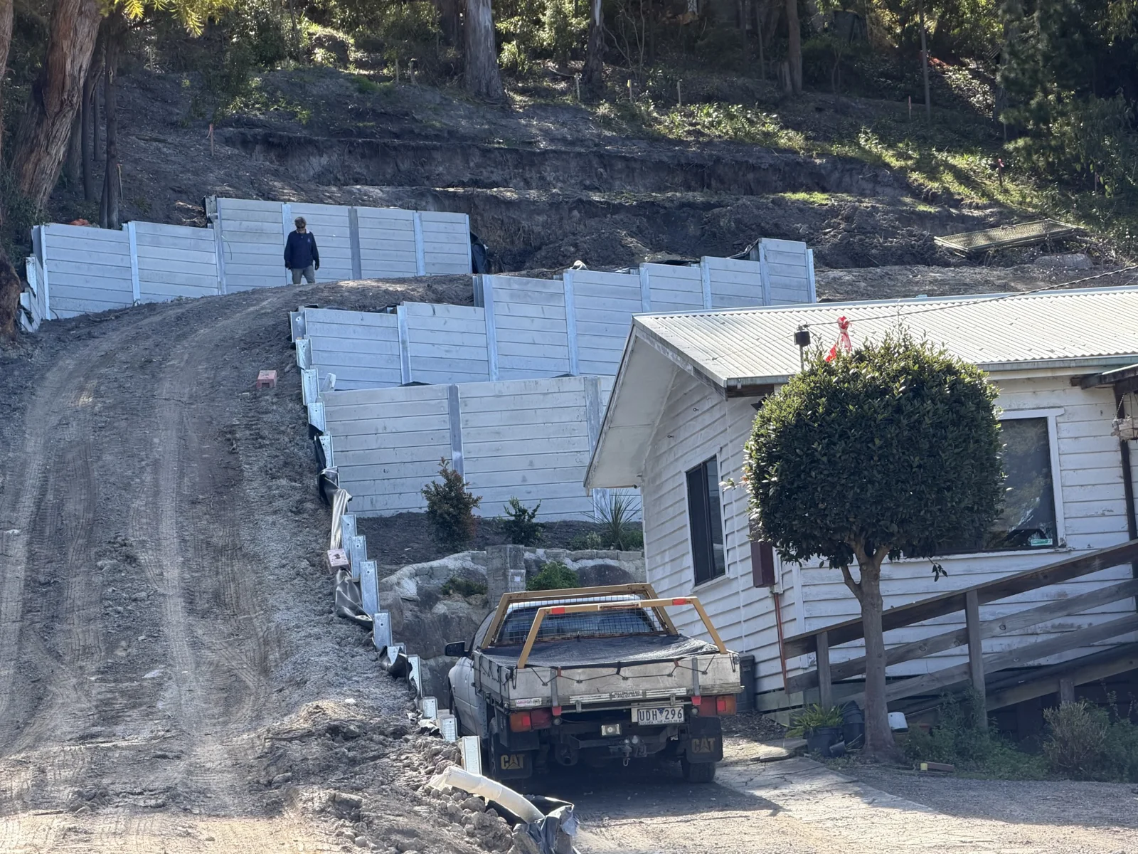 Stepped concrete sleeper retaining walls and excavated ground on the steep clay-based Lorne site